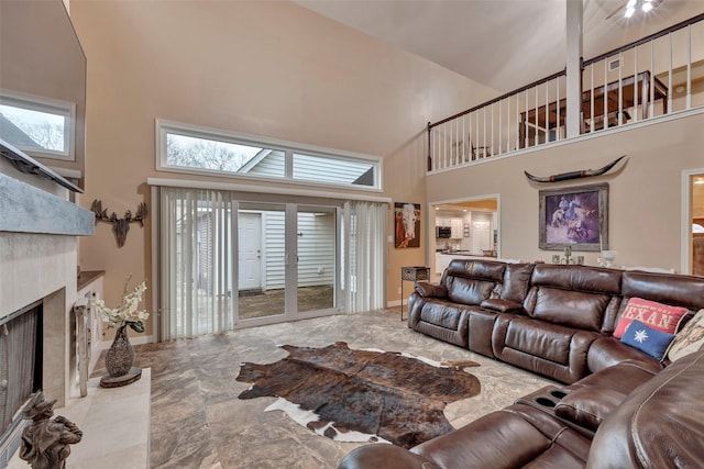 living room with a towering ceiling and a healthy amount of sunlight