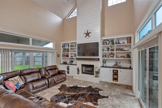 living room featuring a healthy amount of sunlight and a high ceiling