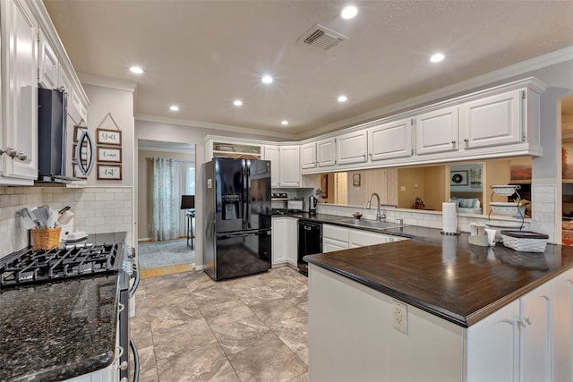 kitchen featuring white cabinets, kitchen peninsula, sink, and black appliances