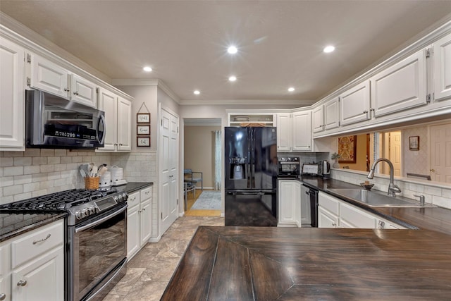 kitchen featuring sink, backsplash, stainless steel appliances, and white cabinets