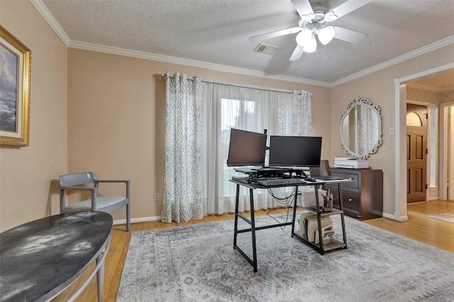 office with crown molding, light hardwood / wood-style flooring, and a textured ceiling