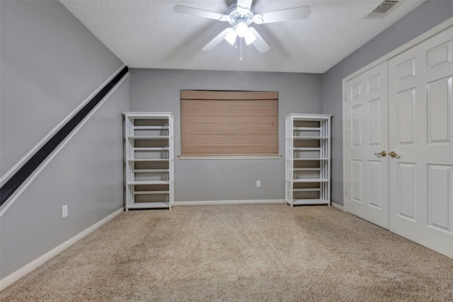 unfurnished bedroom with a closet, a textured ceiling, and carpet flooring