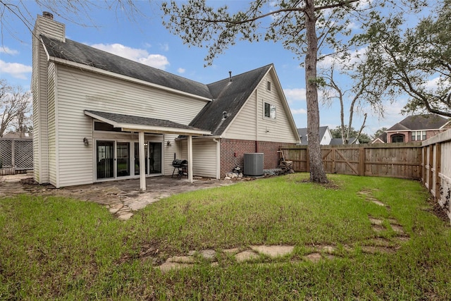 back of property featuring a yard, a patio, and central air condition unit