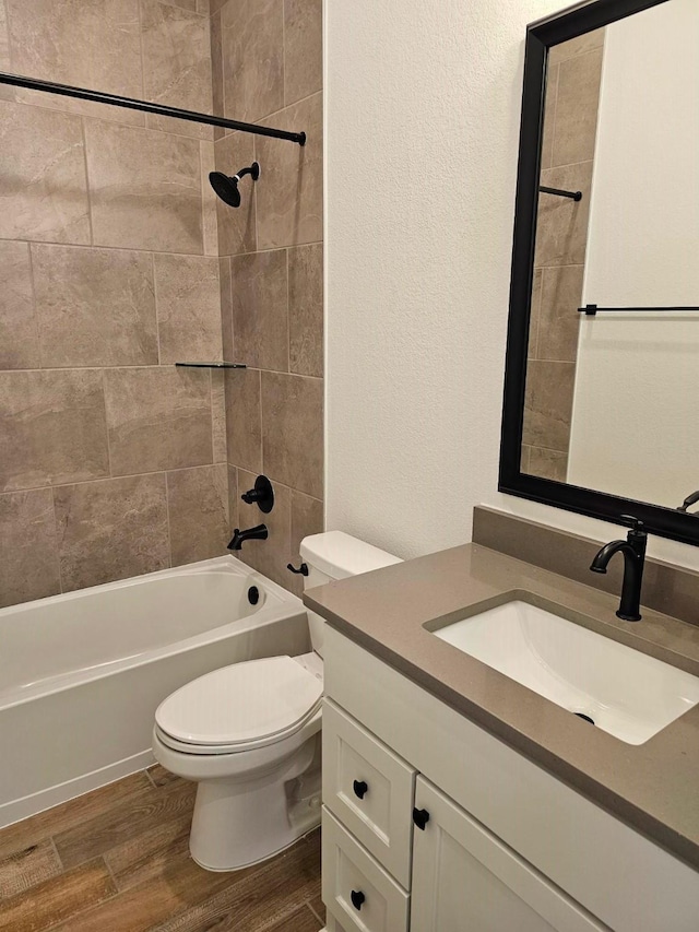 32650 Fly Fish Way, Fulshear, TX 77441 - bathroom featuring wood finished floors, vanity, toilet, shower / washtub combination, and a textured wall