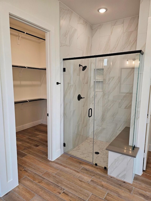 32650 Fly Fish Way, Fulshear, TX 77441 - bathroom featuring wood finished floors, a walk in closet, a stall shower, and recessed lighting