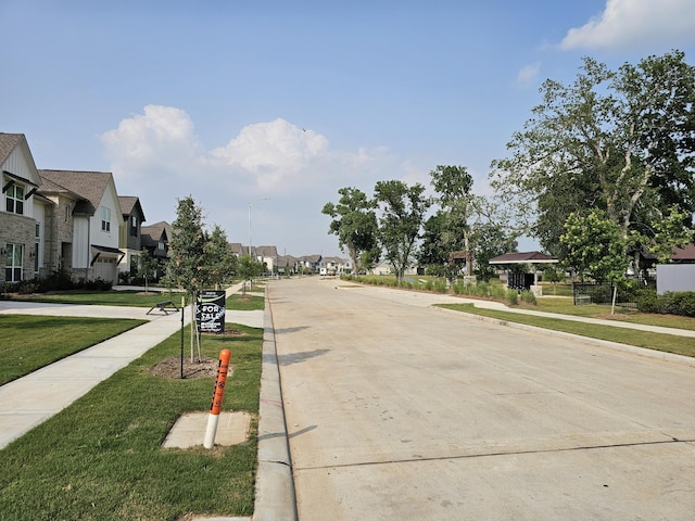 32650 Fly Fish Way, Fulshear, TX 77441 - view of concrete road featuring a residential view, sidewalks, curbs, and street lights