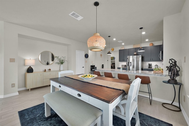 dining space with light hardwood / wood-style flooring