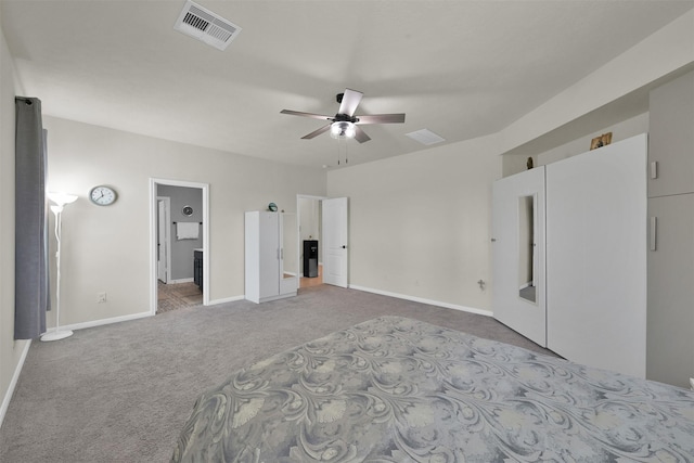 unfurnished bedroom with ensuite bath, carpet floors, and ceiling fan