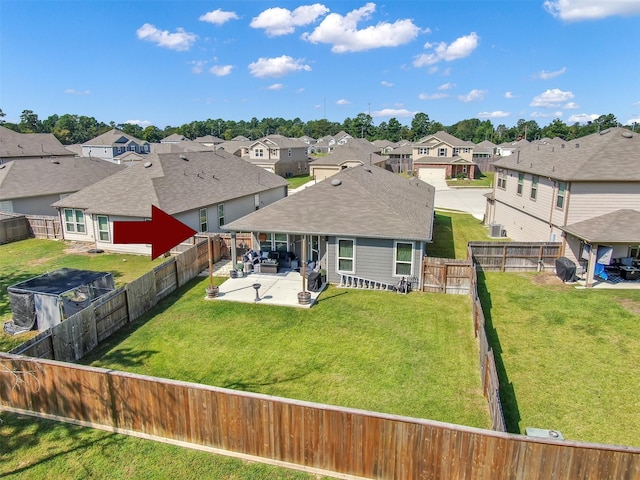 rear view of property featuring a yard and a patio