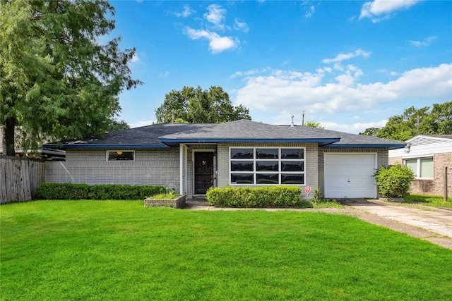 ranch-style house featuring a front lawn and a garage