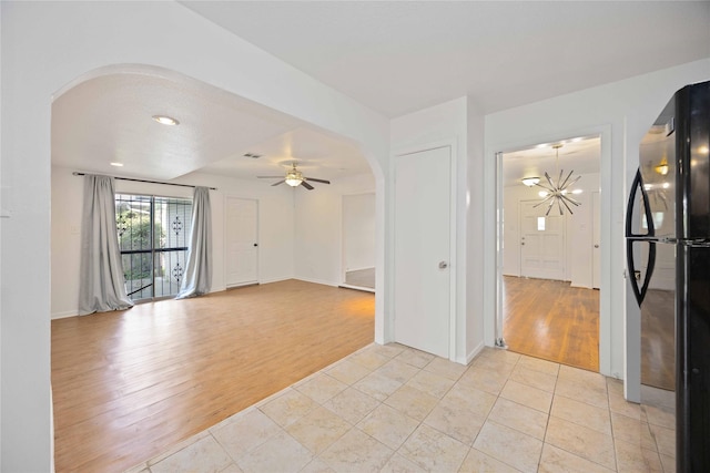 spare room with light tile patterned flooring and ceiling fan