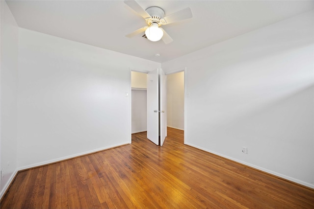 unfurnished bedroom with hardwood / wood-style flooring, ceiling fan, and a closet