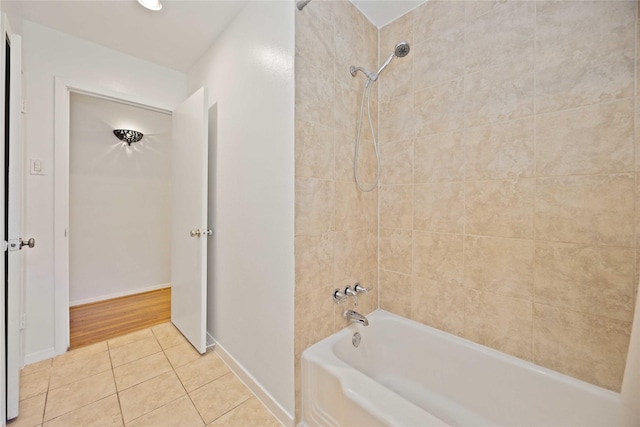 bathroom featuring tiled shower / bath combo and tile patterned flooring