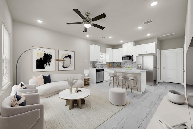 living room featuring sink and ceiling fan