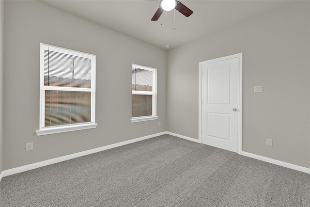 empty room with ceiling fan and carpet flooring