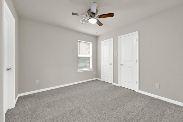 unfurnished bedroom with ceiling fan and carpet