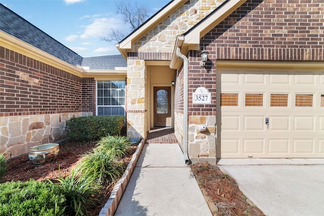 property entrance featuring a garage, stone siding, brick siding, and a shingled roof