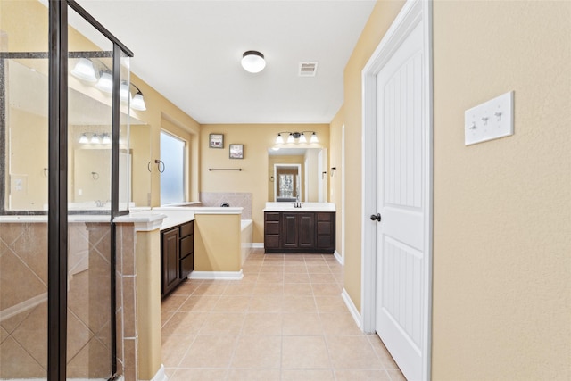 bathroom with tile patterned flooring, a sink, two vanities, visible vents, and a stall shower