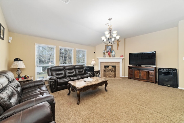 carpeted living room featuring a chandelier, a tiled fireplace, lofted ceiling, and baseboards