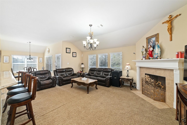 living area with light carpet, vaulted ceiling, and an inviting chandelier