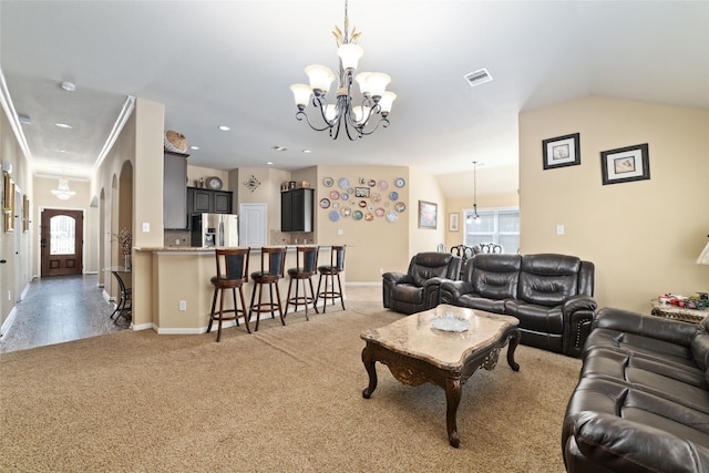 living area featuring an inviting chandelier, baseboards, visible vents, and a wealth of natural light