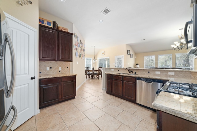 kitchen with hanging light fixtures, visible vents, stainless steel appliances, and a sink