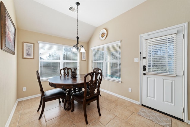 dining room featuring a notable chandelier, light tile patterned floors, visible vents, vaulted ceiling, and baseboards