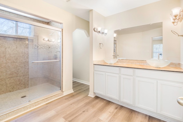 bathroom with vanity, wood-type flooring, and walk in shower