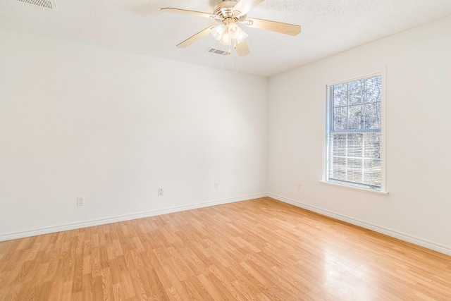 unfurnished room with ceiling fan, light hardwood / wood-style floors, and a textured ceiling