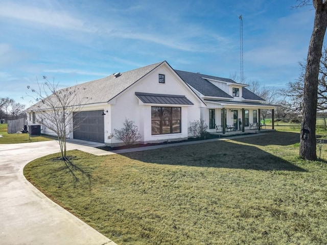 view of front facade with a garage, covered porch, and a front lawn