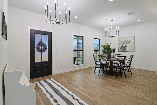 dining room featuring a notable chandelier and light hardwood / wood-style flooring