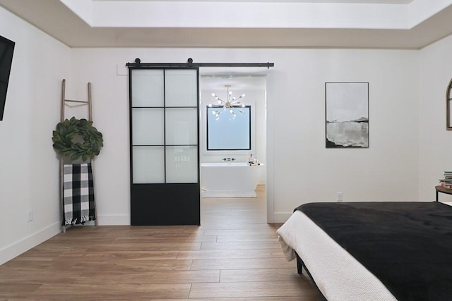 bedroom featuring hardwood / wood-style floors and a notable chandelier