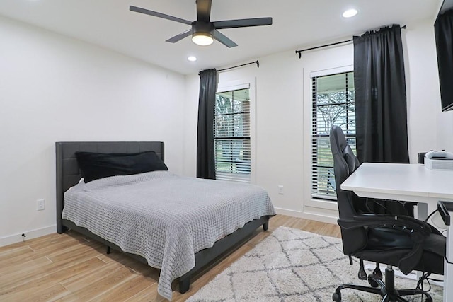 bedroom with ceiling fan and light hardwood / wood-style floors