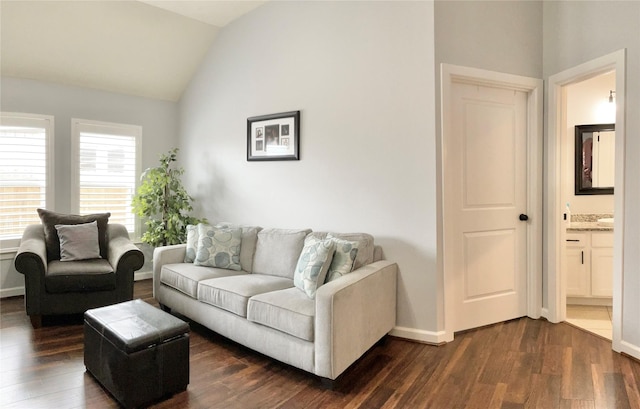 living room with baseboards, vaulted ceiling, and dark wood finished floors