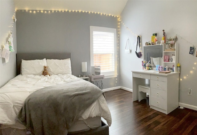 bedroom with baseboards and dark wood-style flooring