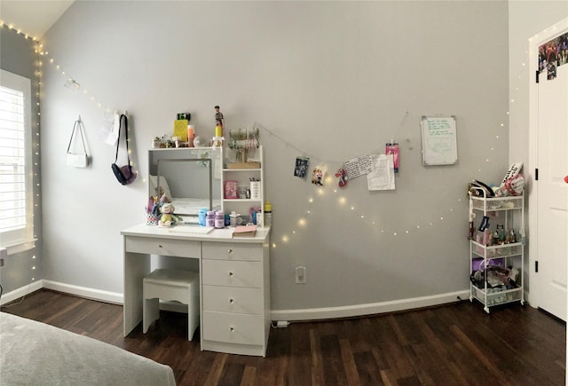 bedroom featuring baseboards and dark wood-type flooring