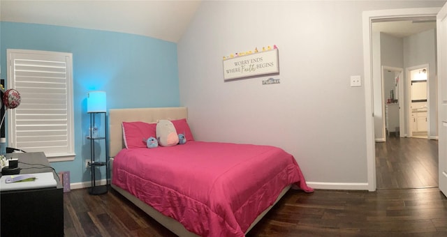 bedroom with dark wood-type flooring, lofted ceiling, and baseboards