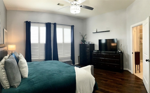 bedroom featuring ceiling fan, baseboards, visible vents, and dark wood finished floors