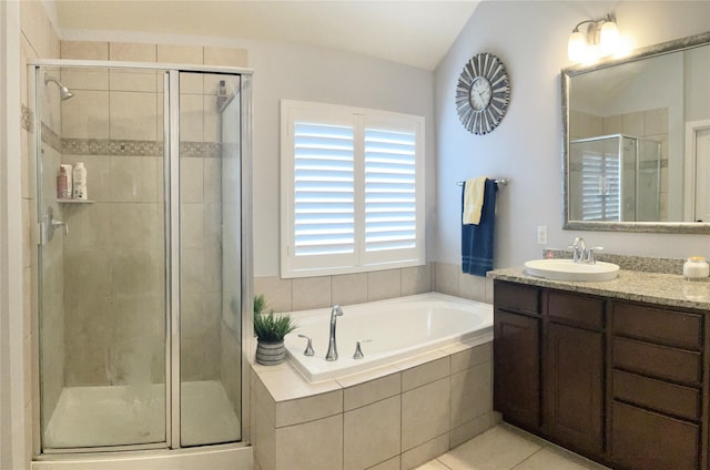 full bathroom featuring tile patterned flooring, vanity, a shower stall, and a bath