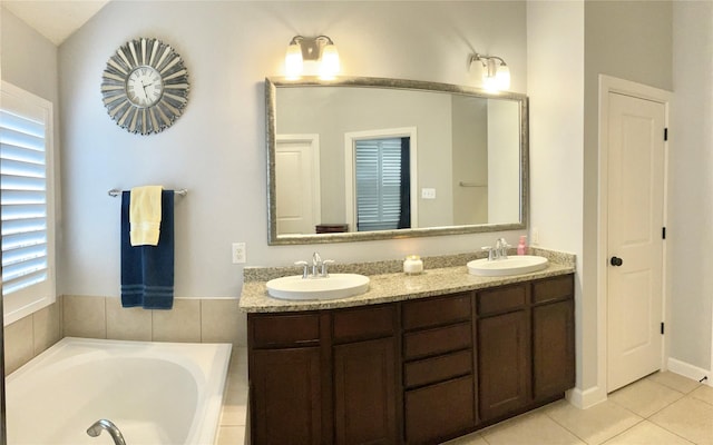 full bathroom with a garden tub, double vanity, tile patterned flooring, and a sink