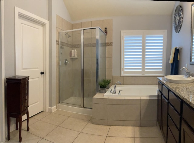 bathroom with a garden tub, a shower stall, vanity, and tile patterned floors