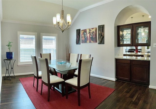 dining room with crown molding, lofted ceiling, dark wood-type flooring, a chandelier, and baseboards