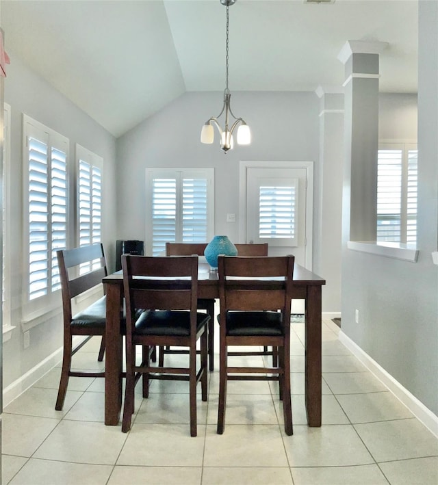 dining space with light tile patterned floors, baseboards, visible vents, lofted ceiling, and a chandelier