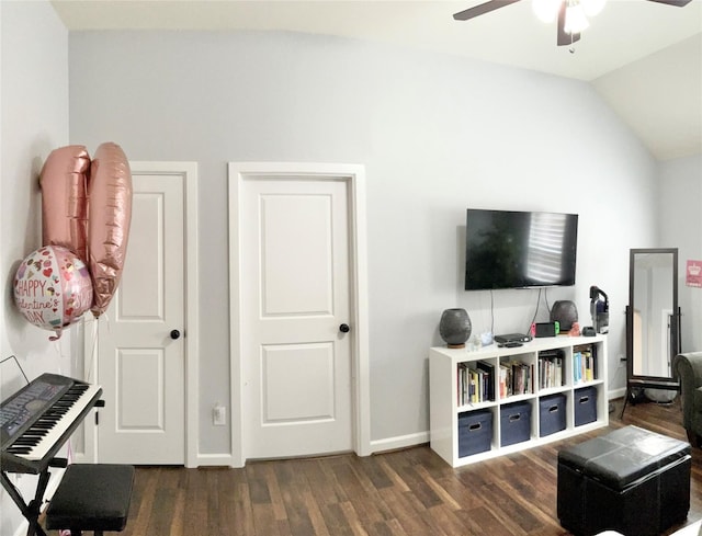 living room with a ceiling fan, lofted ceiling, dark wood finished floors, and baseboards