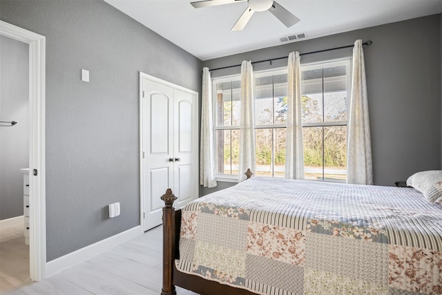 bedroom with a ceiling fan, a closet, visible vents, and baseboards