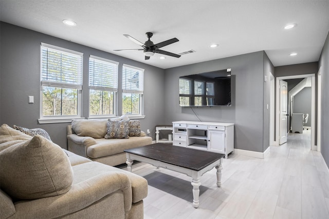 living area with visible vents, recessed lighting, light wood-style flooring, and baseboards