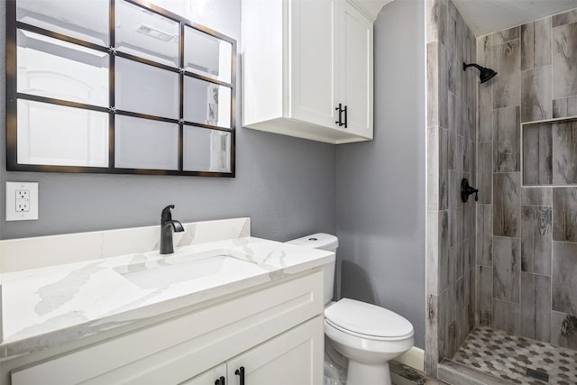 full bath featuring a shower stall, toilet, and vanity