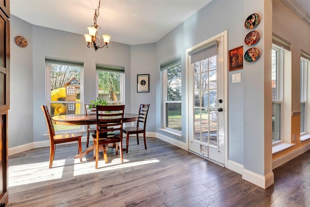 dining room featuring baseboards, a chandelier, and wood finished floors