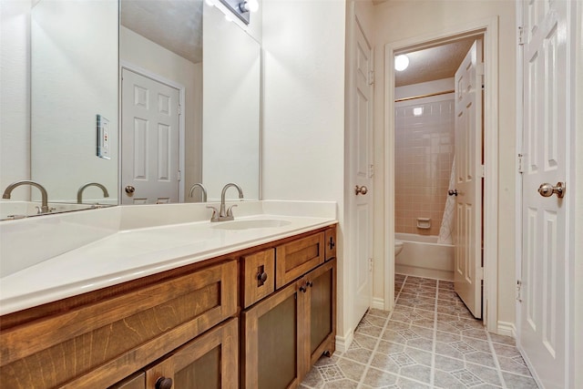 bathroom featuring toilet, shower / bath combination, vanity, and tile patterned floors