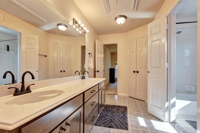 full bathroom featuring a closet, a sink, and double vanity